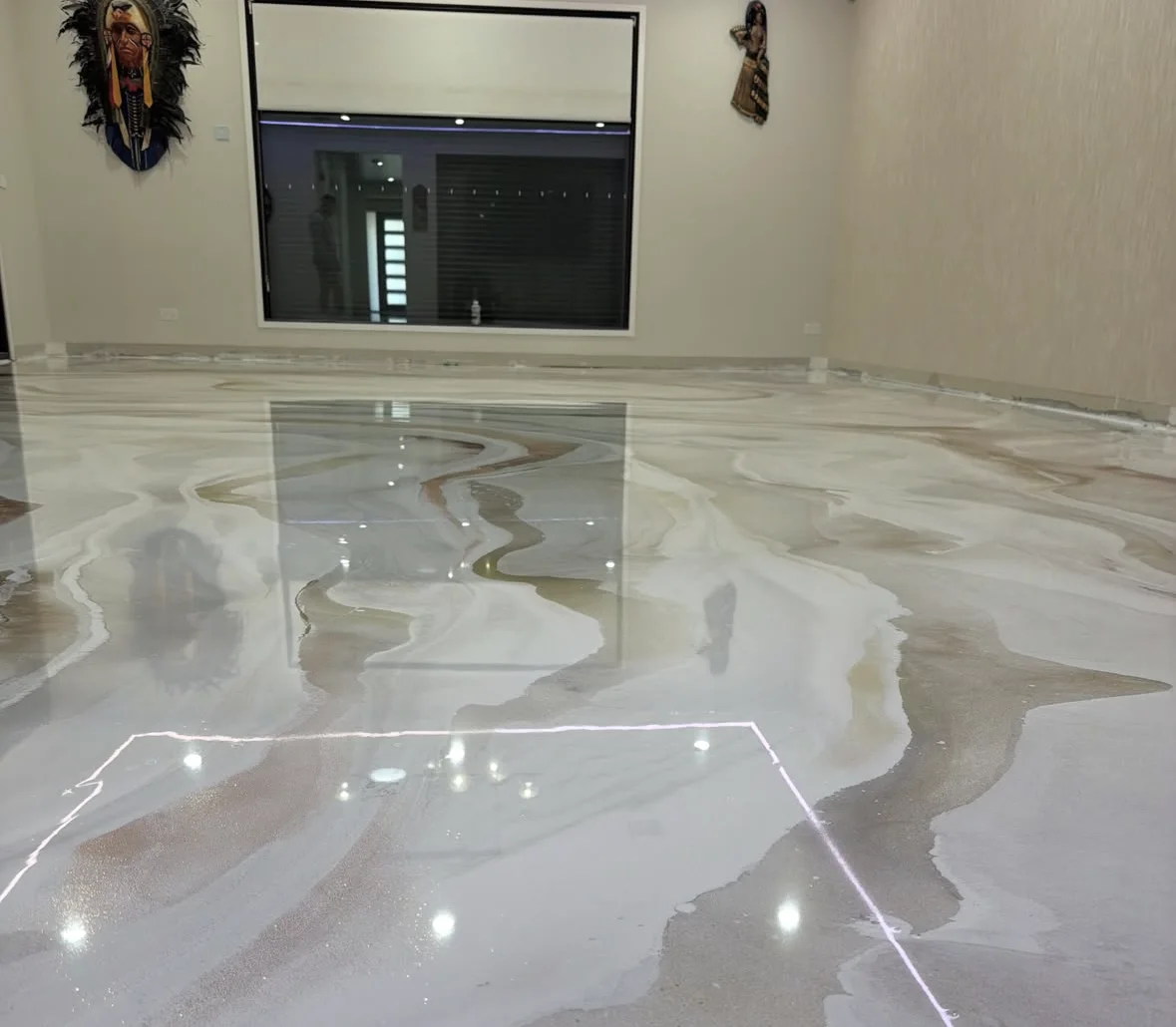 Reflective decorative epoxy floor with bronze and pale tones in a finished interior